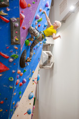 Photo of sports blonde with bag for talc climbing on wall