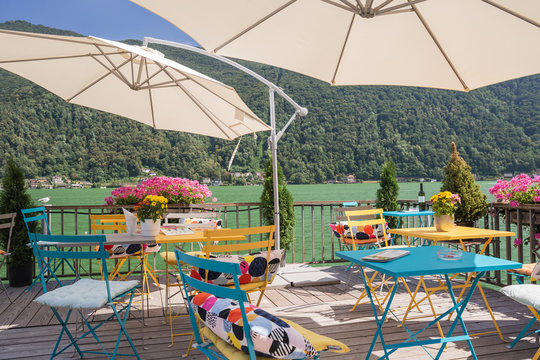 Colorful chairs at bar on Morcote, Ticino, Switzerland