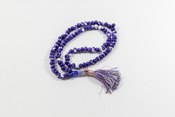 Close-up shot of curved handmade purple islamic prayer beads