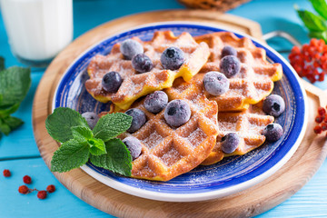 Sweet Homemade Pumpkin Waffles with sugar powder and berries