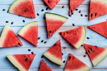 Watermelon slices on a  blue rustic wooden  background, flat lay