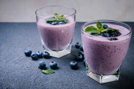  smoothie or shake with fresh blueberries on a dark  background