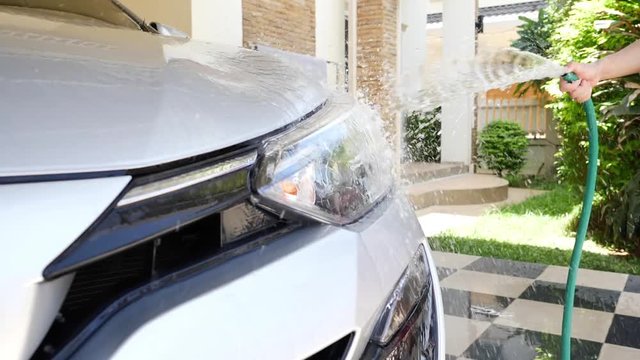 slow motion car wash, water spraying on headlight