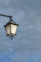 Fototapeta na wymiar Old fashioned street lamp against cloudy sky (with copy space)