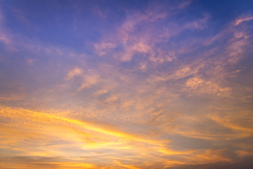 sunset / sun rise sky with rays of yellow and red light shining clouds and sky background and texture