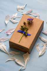 Top view of a gift box wrapped in kraft paper decorated with flower