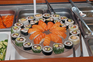 A big glass plate full of sushi