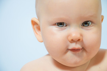 portrait of a serious kid close-up on a homogeneous background
