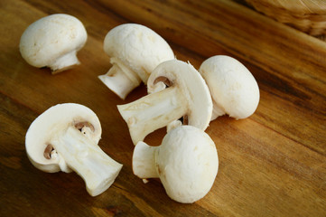 Agaricus bisporus or portobello mushroom on wooden floor.
