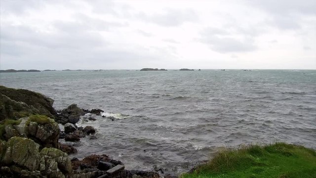 Panning Shot of the Rocky Shores of Loch Uigeadail in Islay