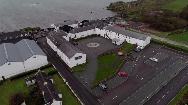 Aerial of a Distillery by the Rocky Shores of Loch Uigeadail in Islay