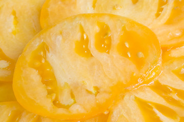Yellow food background, tomato slice