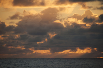 Naklejka na ściany i meble A beautiful view of the sun setting over the Norwegian waters