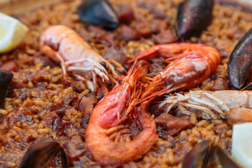 paella in Spanish with seafood and rice in a pan
