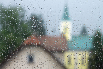 Cityscape through the rainy glass window 