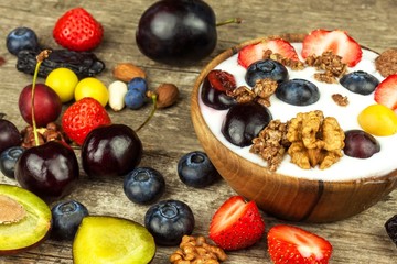Yogurt with summer fruit on an old wooden table. Fruit refreshment. Snack for children.