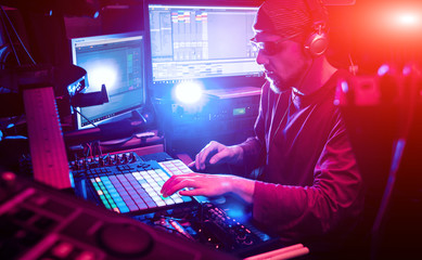 Sound engineer working at mixing panel in the in sound recording studio.