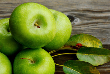 Health Benefits Of Green Apples.
Green apples with leaf on wooden background.