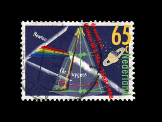 prism splitting light discovered by famous scientist, explorer, astronomer Isaac Newton, planet...