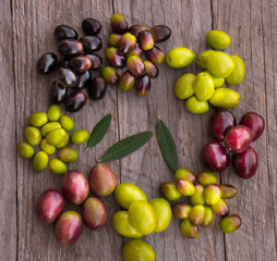 Different types of olives on wood
