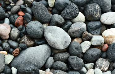 Colorful of stones volcano on Black beach,Thira Island Santorini Greece for wallpaper and texture.