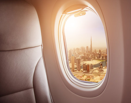 Fototapeta Airplane interior with window view of Dubai city