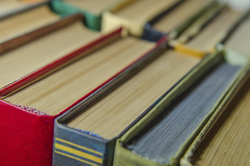 a stack of colorful books on the shelf