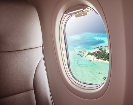 Fototapeta Airplane window with beautiful Maldives island view