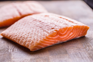 Close-up raw salmon fillets on wooden table