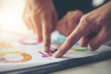 Fototapeta premium businessmen working and point on graph financial diagram and analysis documents on office table