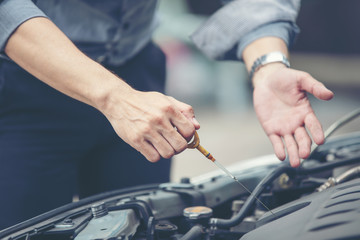 Business men help business women check and repair broken cars