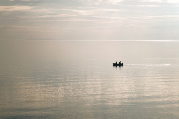 A small boat floats on the sea.