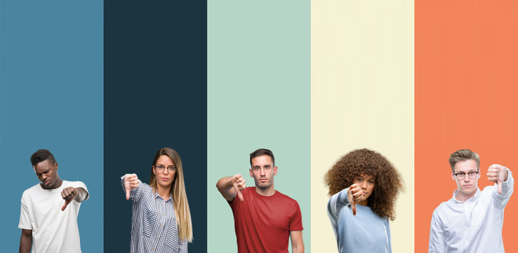Group of people over vintage colors background looking unhappy and angry showing rejection and negative with thumbs down gesture. Bad expression.