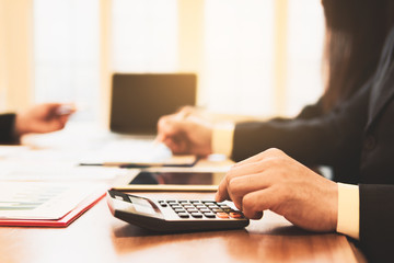 Business concepts,Business teamwork use a pen pointing at graph,Office worker using a tablet and secretary is taking notes,smart phones and graphs on the desk. Meeting in office.