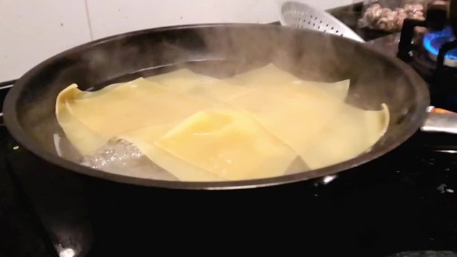 Boiling lasagna sheets in water slow mo