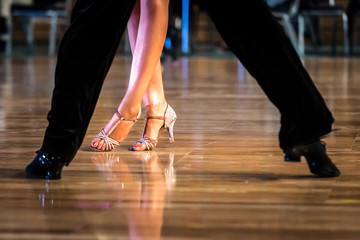 Fototapeta na wymiar Dancing shoes feet and legs of female and male couple ballroom and latin