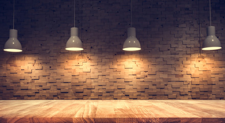 Wood table top on blurred of counter cafe shop with light bulb background.For montage product...