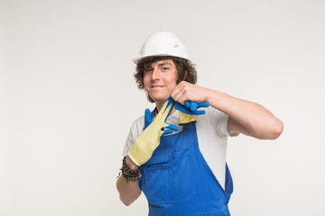 Construction, building and workers concept - Portrait of happy builder in helmet takes off glove.