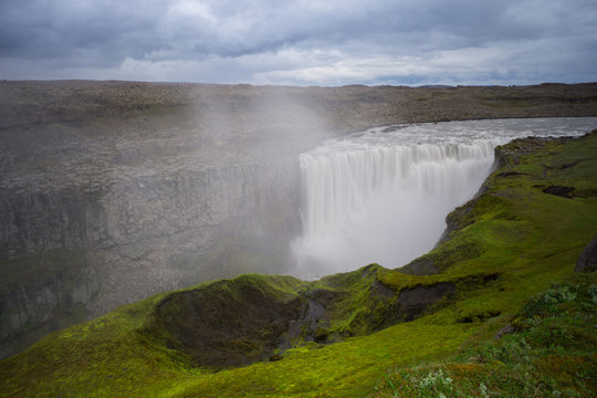 Iceland - Above tremendous detifoss waterfall behind green moss covered area
