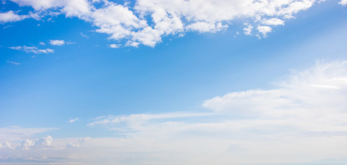 Blue sky background  with white fluffy  clouds. Copyspace.