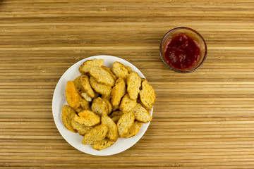 Snacks on a plate. Wooden table. Salty food for beer
