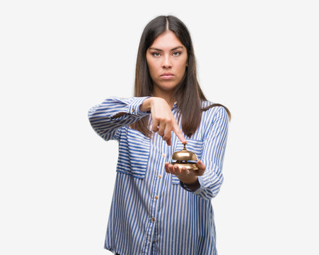 Young Beautiful Hispanic Holding Hotel Ring Bell With A Confident Expression On Smart Face Thinking Serious