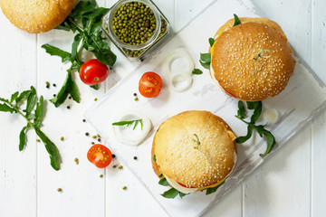Arabic cuisine. Ramadan food. Homemade vegetarian mung cutlets burger on white a wooden kitchen table. Top view flat lay background, copy space.