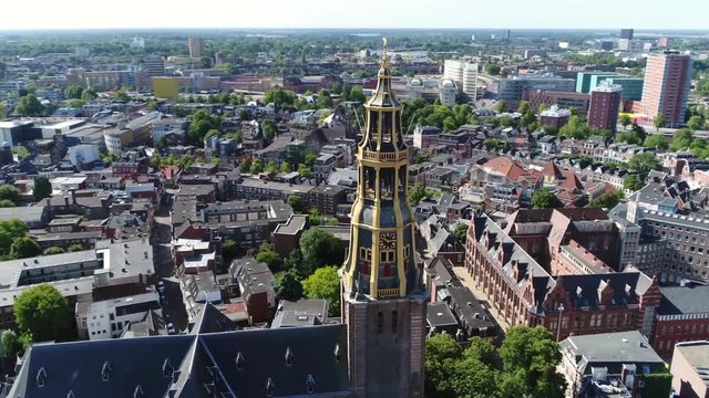 Aerial footage turning camera around the Aa-kerk tower this church is historic parish church in centre of Groningen and dominant feature in skyline of the city together with the nearby Martinitoren 4k