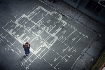 Woman engineer thinking over his plan. Mixed media