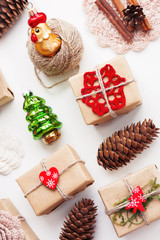 Christmas and New Year background with handmade presents wrapped in craft paper and decorations, holiday symbols.