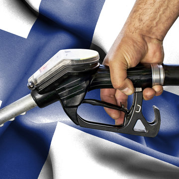 Gasoline consumption concept - Hand holding hose against flag of Finland