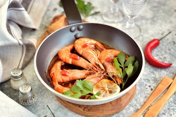 Fried big shrimps in tomato sauce with olive oil, garlic, ginger, chili and soy sauce