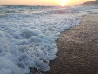 sunset sea waves foam splash  in summer Preveza Vrahos Greece