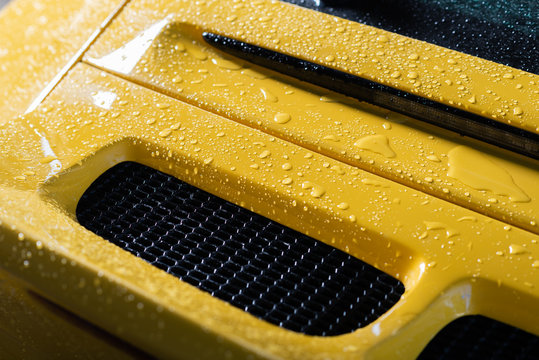 Fototapeta Car detailing series: Yellow sports car being washed